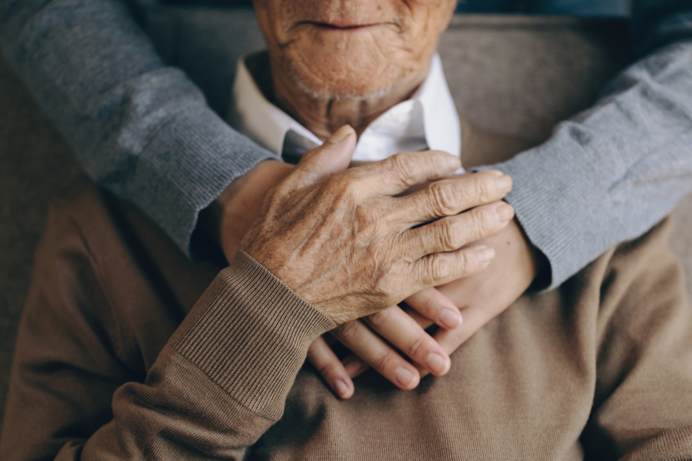 daughter hugging a senior man