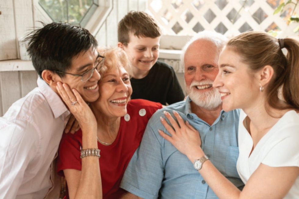 Family hugging grandparents